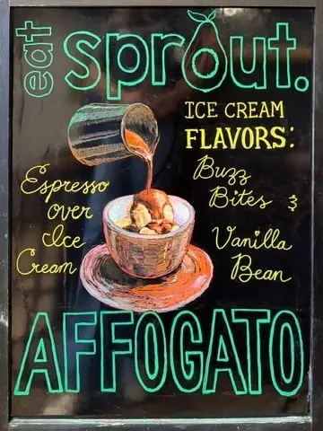 Chalkboard sign for "Eat Sprout" illustrated with a cup of affogato being poured over ice cream, hand-lettered in chalk marker